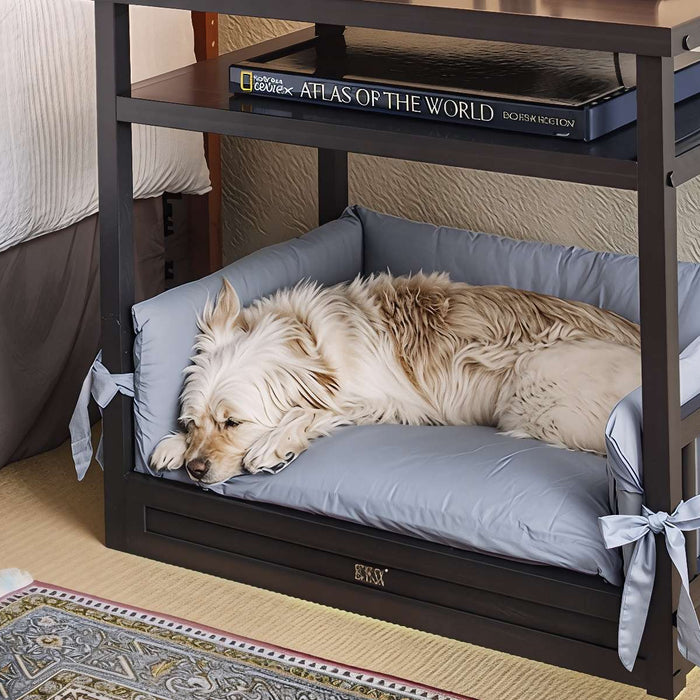A fluffy dog naps in a cushioned bed under a nightstand, showing Why Are Dog Beds Elevated for comfort and space-saving