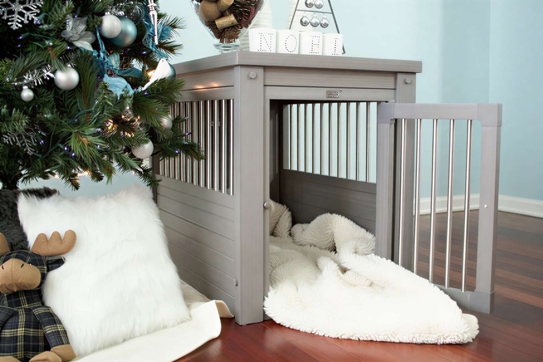 Cozy gray furniture-style dog crate beside a decorated Christmas tree, showing a stylish indoor solution for dog crate problems