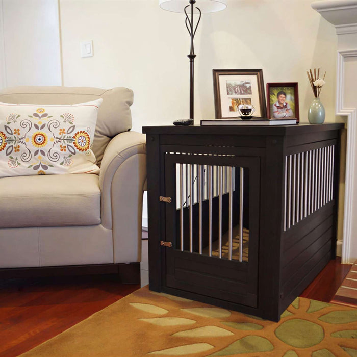Dark wood decorative dog crate with metal bars styled as a side table beside a beige armchair in a cozy living room