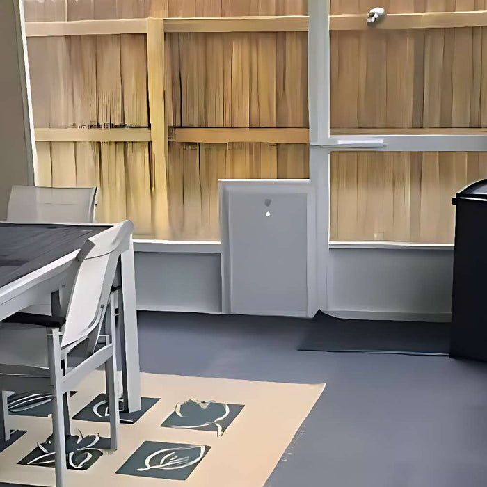 Modern patio setup with a table, chairs, and a pet door shows how to weatherproof a dog door