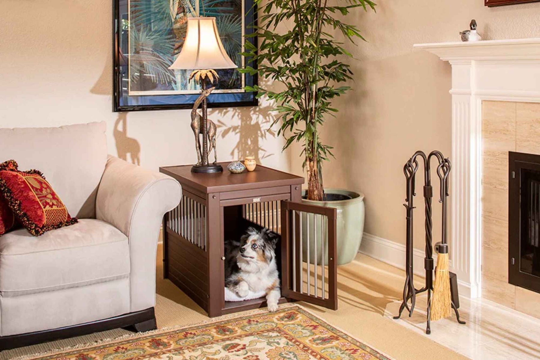 The wooden crate blends into the living room decor with a lamp and sculpture on top, showing one of the 6 Benefits of Using a Wooden Dog Crate