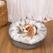 A Cavalier King Charles Spaniel is nestled in the Ultra Plush Arctic Fox Paw PupPouf™ Luxe Faux Fur Donut Dog Bed near a white curtain