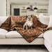 A French bulldog sitting on a couch draped with the Paw PupProtector™ Short Fur Waterproof Throw Blanket - Sable Tan