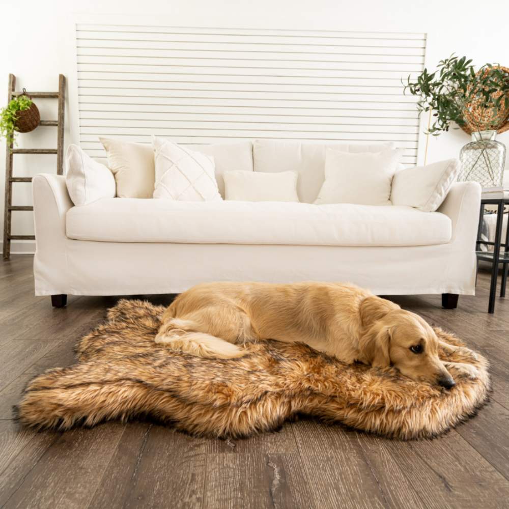 A Golden Retriever lying on a Curve Sable Tan Paw PupRug Faux Fur Orthopedic Dog Bed in a cozy living room