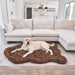 A Labrador retriever is lying on the Curve Brown Paw PupRug Faux Fur Orthopedic Dog Bed in a modern living room with a white sectional sofa