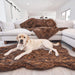 A Labrador retriever is resting on the Curve Brown Paw PupRug Faux Fur Orthopedic Dog Bed in a living room with matching brown fur decor