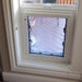 A Security Boss Pet Door Spacer installed within a window frame