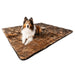 A Shetland Sheepdog is lying on the floor with a Paw PupProtector™ Waterproof Throw Blanket - Sable Tan Dog Bed Blankets