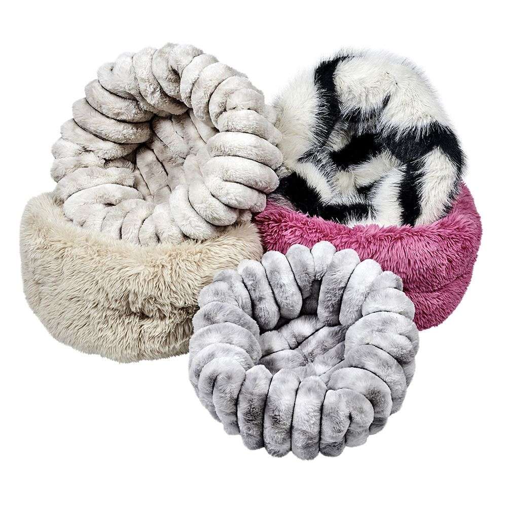 A group of plush, round Bowsers The Muffy Dog Bed styles in various colors and textures like beige, gray, pink, and black-and-white