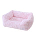 A baby pink, rectangular, plush dog bed with soft, furry fabric. The label reads Hello Doggie Bella Dog Bed