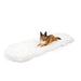 The Paw PupRug™ Runner Faux Fur Memory Foam Dog Bed Curve Polar White displayed on its own, showcasing its plush texture and unique shape