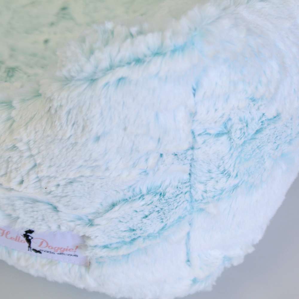 A close-up detail of the Hello Doggie Whisper Dog Bed in aqua, showing the fluffy and plush texture of the fabric