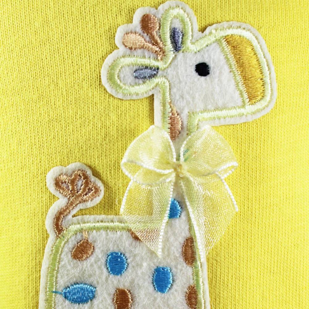 A close-up of the Hello Doggie Baby Safari Dog Dress showcases the detailed embroidery of a giraffe, complete with a small bow on its neck