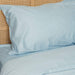 A close-up shot of a pillow and bedding in a light blue color, highlighting the Paw PupSheets™ Hair Resistant, Antimicrobial, & Cooling Duvet Cover and Sheet Set Bundle - Sky Blue