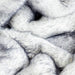 A close-up shot showcases the luxurious texture of the Ultra Plush Arctic Fox Paw PupPouf™ Luxe Faux Fur Donut Dog Bed