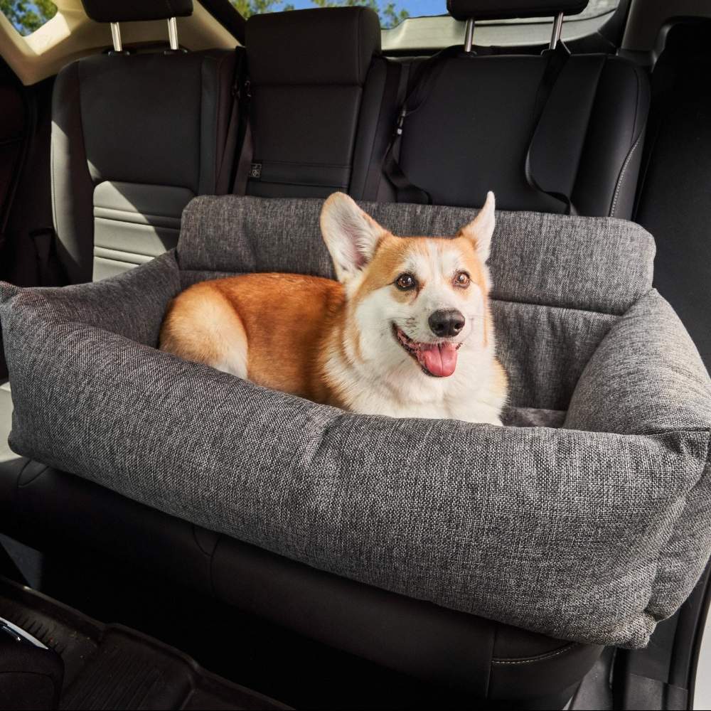 A corgi dog is lying comfortably in the back seat of a car on a Paw PupProtector™ Memory Foam Dog Car Bed - Double Vehicle Seat