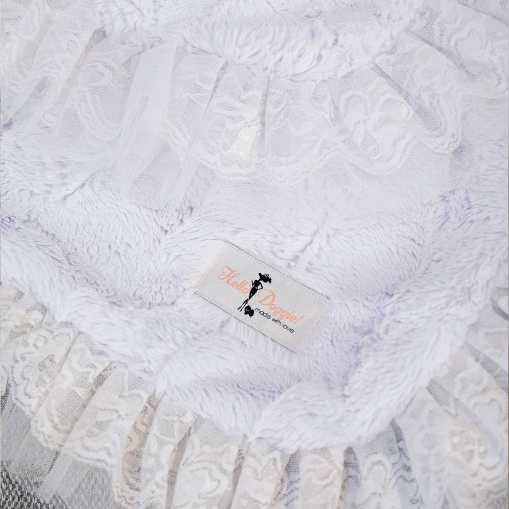 A detailed shot of the blanket features the lace trim and a label, providing a closer look at the intricate craftsmanship of the Hello Doggie Romantic Dog Blanket in the Heaven color