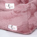 A detailed view of the Hello Doggie Cuddle Dog Bed in mauve