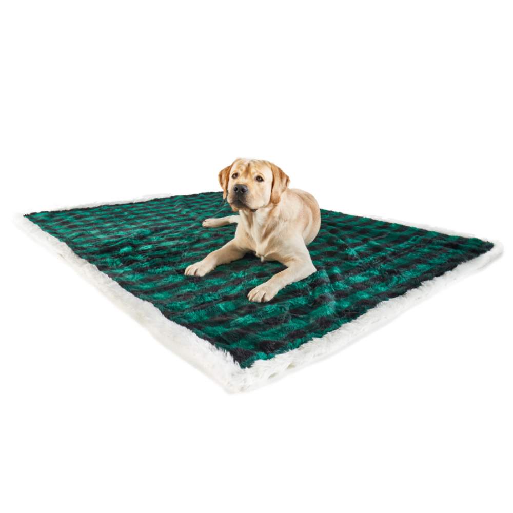 A dog is lying on the Paw PupProtector™ Waterproof Throw Blanket - Green Buffalo Plaid spread out on the floor