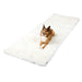 A dog is lying on the floor on top of the Paw PupProtector™ Waterproof Bed Runner - Polar White