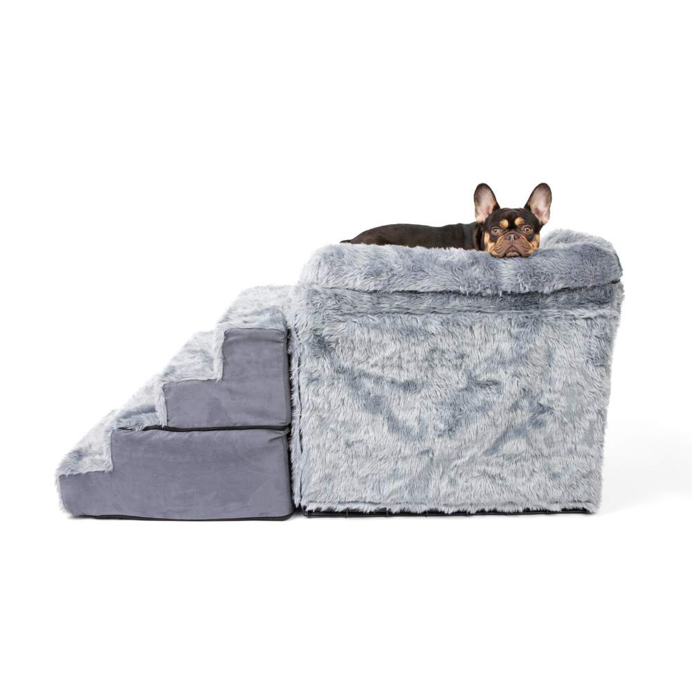 A dog is lying on top of the Paw Pet Bedside Sleeper Crate Kit & Stairs in a side view