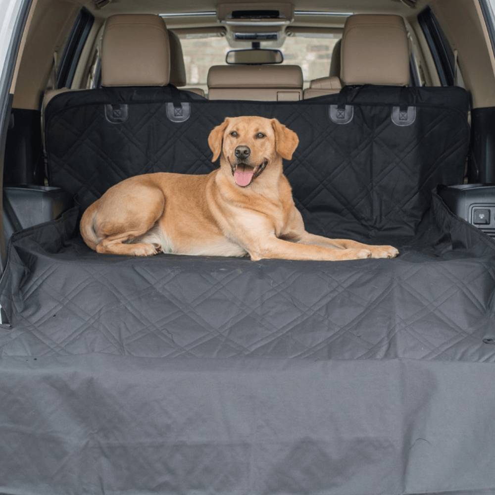 A dog lying comfortably on the Paw PupProtector™ Cargo Cover Liner for SUVs and Cars, showcasing its protective and comfortable design