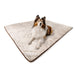 A fluffy dog is sitting on the Paw PupProtector™ Short Fur Waterproof Throw Blanket - White with Brown Accents