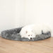 A fluffy white dog is lying down on the Charcoal Grey Paw PupRug™ Memory Foam Corner Dog Bed, comfortably positioned in a room corner