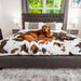 A golden retriever is lying on a bed with the Paw PupProtector™ Waterproof Throw Blanket - Brown Faux Cowhide Indestructible Dog Blankets