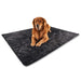 A golden retriever is lying on the Paw PupProtector™ Short Fur Waterproof Throw Blanket - Midnight Black Dog Blanket