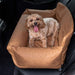 A happy dog is comfortably resting in the Paw PupProtector™ Faux Leather Memory Foam Dog Car Bed - Camel Double Seat, placed in a car seat