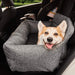 A happy dog is laying comfortably in the back seat of a car on a Paw PupProtector™ Memory Foam Dog Car Bed - Double Seat