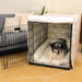 A happy dog sits inside a black wire crate lined with soft white padding from the Paw Upgrade Your Dog Crate Kit - Polar White