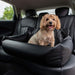 A happy dog sitting in the back seat, safely enclosed in the Paw PupProtector™ Faux Leather Memory Foam Dog Car Bed - Black Double Seat