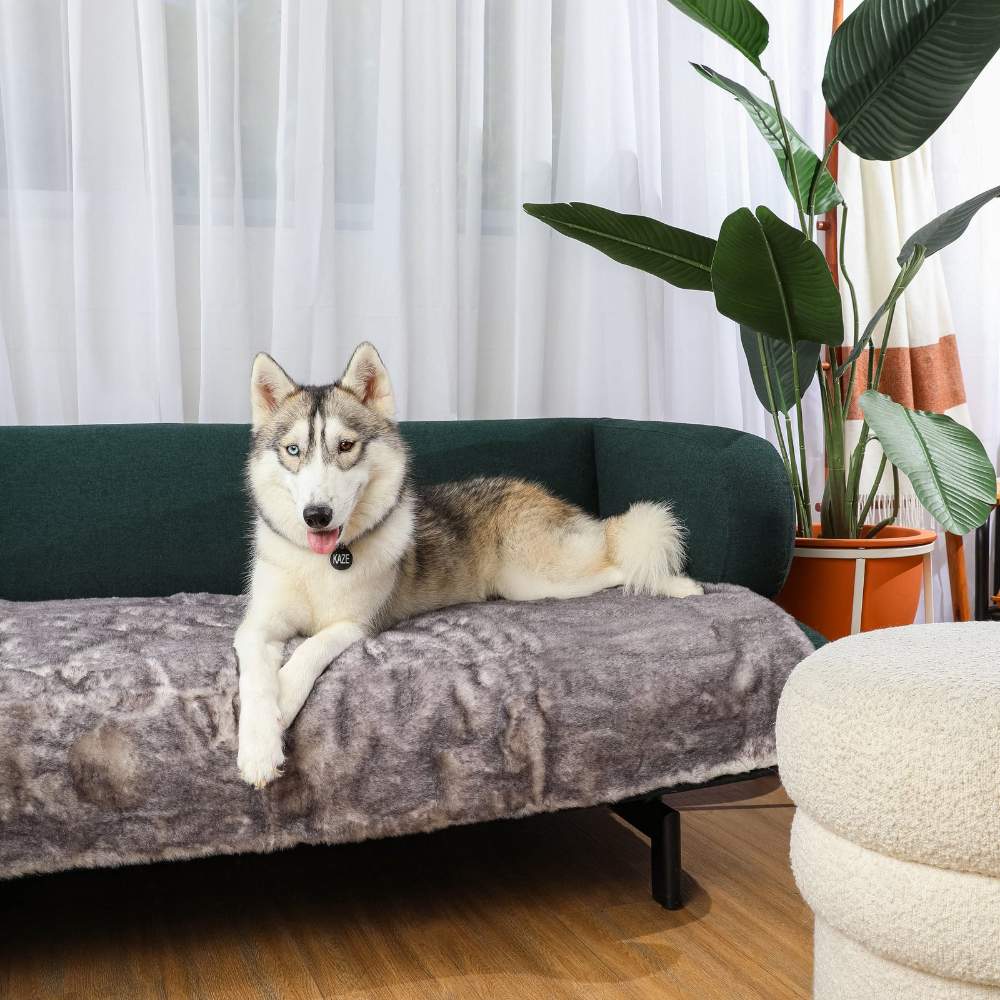 A husky is comfortably lounging on a sofa covered with the Paw PupProtector™ Waterproof Bed Runner - Ultra Soft Chinchilla