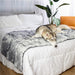 A husky is lying on a bed covered with the Paw PupProtector™ Waterproof Bed Runner - Ultra Plush Arctic Fox Dog Blankets