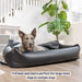 A large dog is comfortably lying in a Paw PupProtector™ Faux Leather Memory Foam Dog Car Bed - Black Full Back Seat Portable Dog Bed