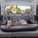 A large dog is lying comfortably on the back seat in the Paw PupProtector™ Faux Leather Memory Foam Dog Car Bed - Black Ful Back Seat