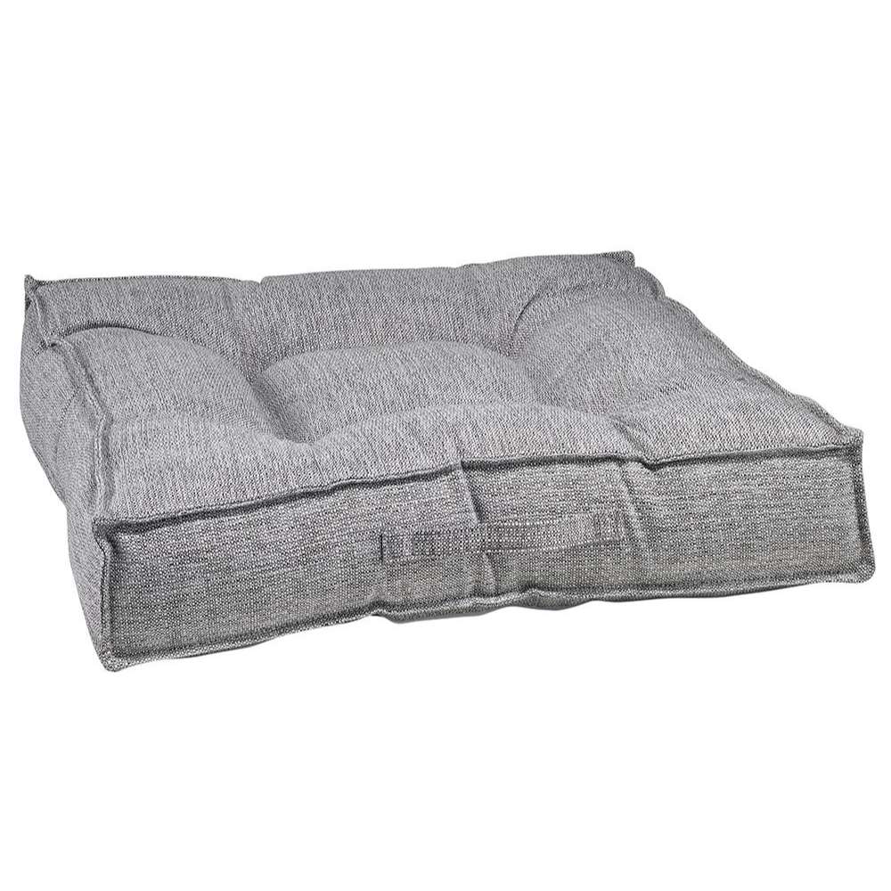 Allumina Bowsers Piazza Dog Bed in gray woven fabric features a plush tufted cushion with raised padded edges for cozy comfort