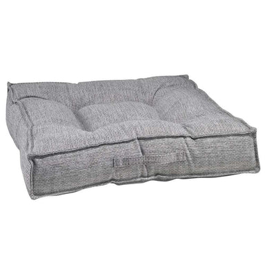 Allumina Bowsers Piazza Dog Bed in gray woven fabric features a plush tufted cushion with raised padded edges for cozy comfort