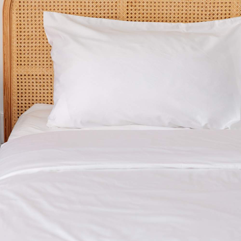An empty bed showcasing the Paw PupSheets™ Hair Resistant, Antimicrobial, & Cooling Duvet Cover and Sham Set - White, highlighting its pristine appearance