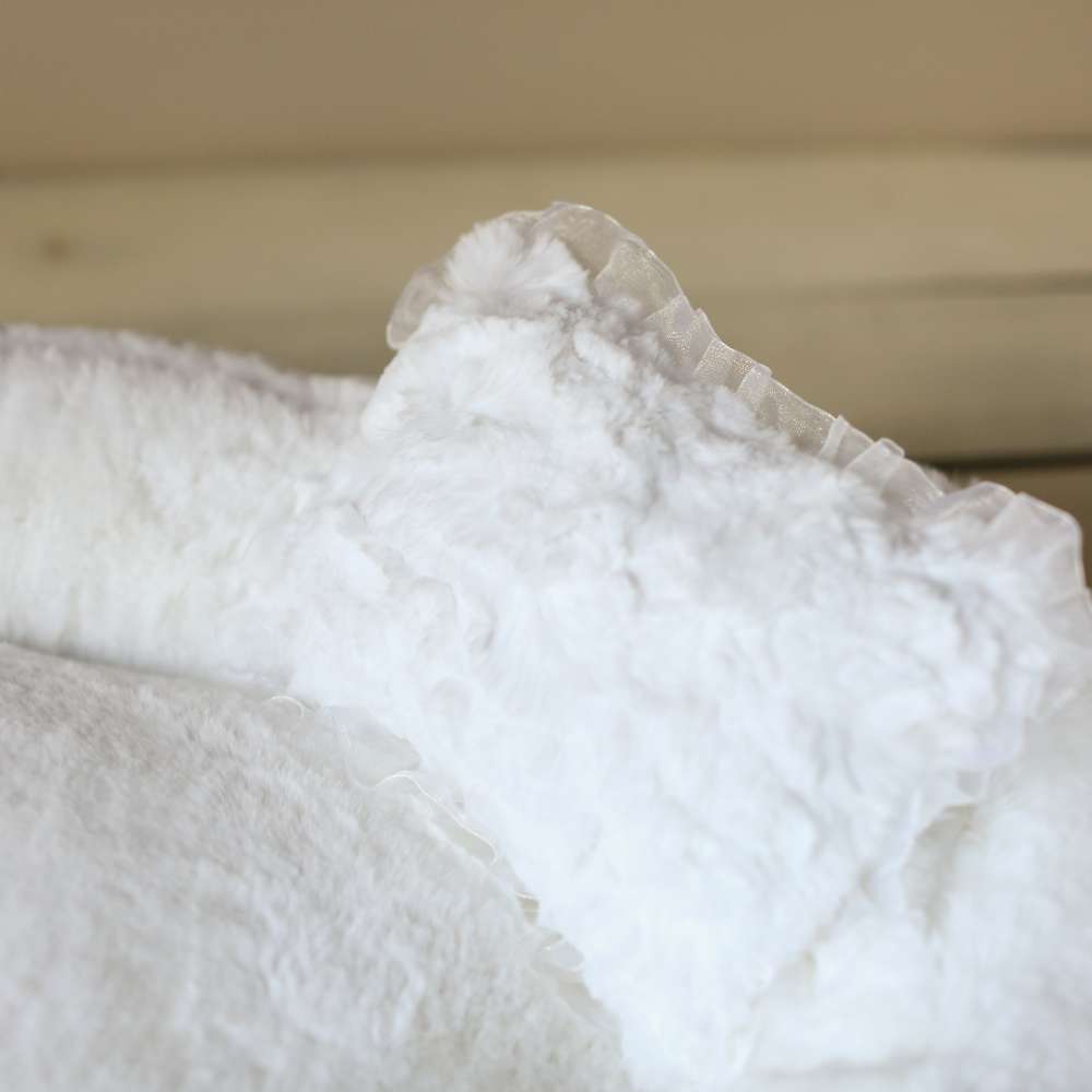 An image is a close-up of the white pillow with ruffles from the Hello Doggie Divine Dog Bed collection