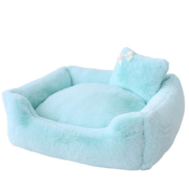 An image shows the Hello Doggie Divine Dog Bed in a light icy blue color, featuring a plush design with a small white bow on the pillow