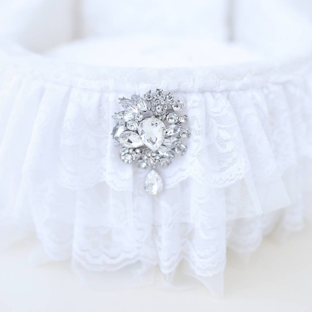 Another detailed view of the decorative brooch on the Hello Doggie Crib Dog Bed in white, emphasizing the luxurious lace ruffles and brilliant crystal details