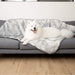 Another view of the fluffy white dog comfortably lying on the Paw PupProtector™ Waterproof Throw Blanket - Ultra Plush Arctic Fox on a couch