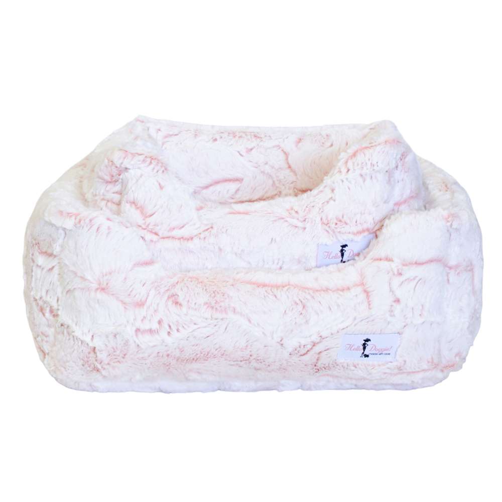 A pair of Hello Doggie Whisper Dog Bed in peach are shown nested together in this image