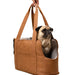 A pug being carried in the Paw PupTote™ 3-in-1 Faux Leather Dog Carrier Bag - Camel with the carrier being held by its straps
