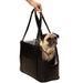 A pug being held in the Paw PupTote™ 3-in-1 Faux Leather Dog Carrier Bag - Black with the carrier's straps visible