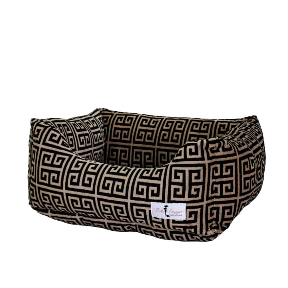 A rectangular Hello Doggie Obsidian Dog Bed with a black and tan Greek key pattern