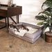 A relaxed dog lying on the Paw PupLounge™ Memory Foam Bolster Dog Bed & Topper, placed in a stylish home setting